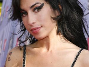  FILE  Singer Amy Winehouse arrives at the MTV Movie Awards in Los Angeles, in this June 3, 2007, file photo. Winehouse has canceled all concerts and public appearances for the rest of the year on the advice of her doctor.   quot;The rigors involved in touring and the intense emotional strain that Amy has been under in recent weeks have taken their toll, quot; said Tracey Miller, the 24-year-old British soul singer apos;s representative, in a statement Tuesday, Nov. 27, 2007.  AP PhotoKevork Djansezian, file